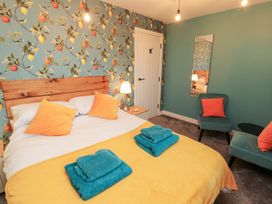 A bedroom with a bed and chair at 10 Keekle Terrace in Keekle near Cleator Moor