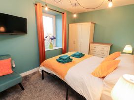 A bedroom with a bed and television at 10 Keekle Terrace in Keekle near Cleator Moor