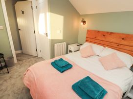 A bedroom with a bed and nightstand at 10 Keekle Terrace in Keekle near Cleator Moor