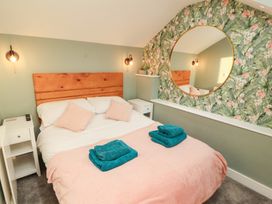 A bedroom with a bed and bedside table at 10 Keekle Terrace in Keekle near Cleator Moor
