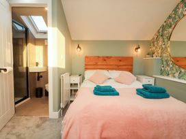 A bedroom with a bed and ensuite bathroom at 10 Keekle Terrace in Keekle near Cleator Moor