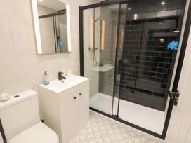 A bathroom with a toilet, sink, and shower at 10 Keekle Terrace, Keekle near Cleator Moor