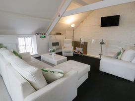 A living room with a sofa and armchair at The Old Workshop in Dre-Fach near Lampeter