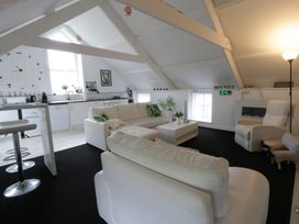 A living room with a sofa and table at The Old Workshop in Dre-Fach near Lampeter