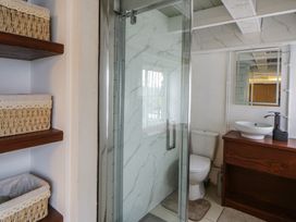 A bathroom with a shower, toilet, and sink at The Old Workshop in Dre-Fach near Lampeter