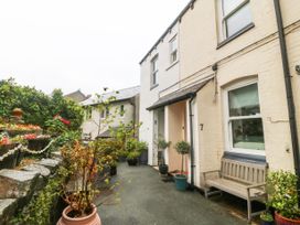 A front garden area with potted plants a bench and house entrances numbered 7 and 8 at Terrace View in Trefriw near Llanrwst