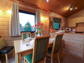 A dining room with a table and chairs at Elderberrys Lodge in Bideford