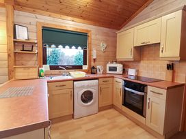 A kitchen with appliances and a sink at Elderberrys Lodge in Bideford