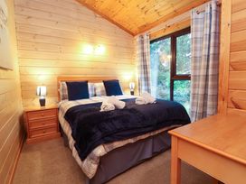 A bedroom with a bed and window at Elderberrys Lodge in Bideford