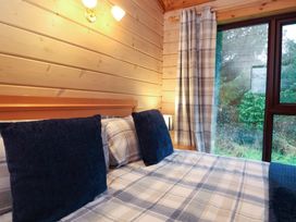 A bedroom with a bed and window at Elderberrys Lodge in Bideford