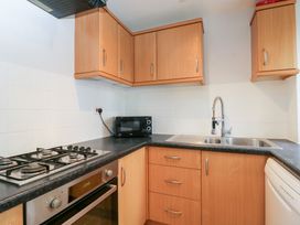 A kitchen with a sink, stove, and microwave at 20 Honeycroft Bourton-On-The-Water
