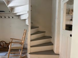 A staircase and rocking chair in an entrance hall at Field View in Ruswarp