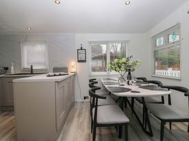 A kitchen with a dining area and table set at Cosy Corner White Cross Bay near Troutbeck Bridge