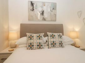 A bedroom with a bed and bedside lamps at Cosy Corner White Cross Bay near Troutbeck Bridge