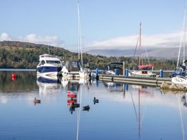 A marina with boats and ducks on the water at Cosy Corner White Cross Bay near Troutbeck Bridge