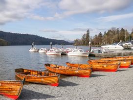 A row of rowboats with motorboats in the background at Cosy Corner White Cross Bay near Troutbeck Bridge