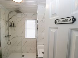 A bathroom featuring a shower and sink at Cosy Corner in White Cross Bay near Troutbeck Bridge