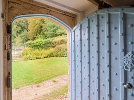 An entrance door leading to a garden area at Hole House in Branscombe