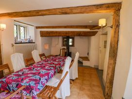 A dining room with a table and chairs at Hole House in Branscombe