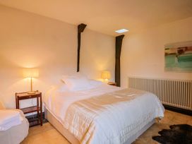 A bedroom with a bed and lamp at Hole House in Branscombe