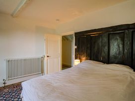 A bedroom with a bed and radiator at Hole House in Branscombe