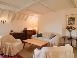 A living room with a sofa and armchairs at Hole House in Branscombe