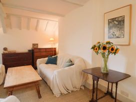 A living room with a sofa and coffee table at Hole House in Branscombe