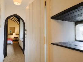 A hallway with an archway leading to a bedroom at Hole House in Branscombe