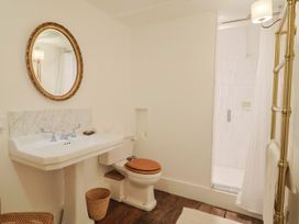 A bathroom featuring a sink and a toilet at Hole House in Branscombe