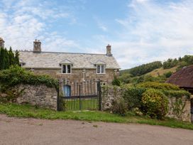 A house with a gate and stone wall at Hole House in Branscombe