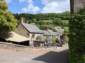 A street with houses and outdoor seating area at Hole House in Branscombe