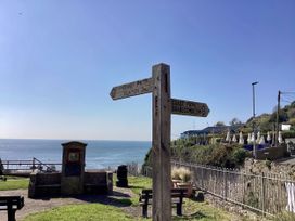 A signpost indicating directions to Branscombe and Seaton near the coast at Hole House in Branscombe