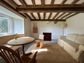 A living room with a table and chairs at Hole House in Branscombe