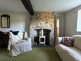 A living room with a fireplace and two sofas at Hole House in Branscombe