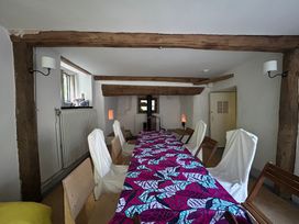 A dining room with a table and chairs at Hole House in Branscombe