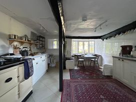 A kitchen with a stove and table at Hole House in Branscombe