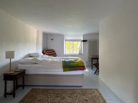 A bedroom with a bed and a table at Hole House in Branscombe