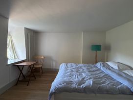 A bedroom with a bed and a table at Hole House in Branscombe