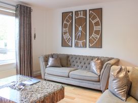 A living room with a sofa and coffee table at The Old Police House in Salcombe