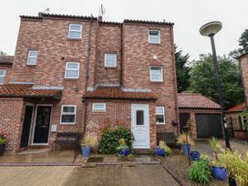 Front view of a brick townhouse with multiple windows and entrances at New Tower House 10 Pear Tree Court York
