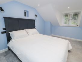 A bedroom with a bed and a window at Frongoch Old Power House in Dolgellau