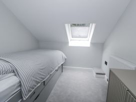 A bedroom with a bed and window at Frongoch Old Power House in Dolgellau