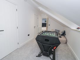 A game room with a foosball table and couch at Frongoch Old Power House Dolgellau