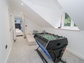 A games room with a foosball table and bed at Frongoch Old Power House in Dolgellau