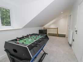 A game room with a foosball table and window at Frongoch Old Power House in Dolgellau