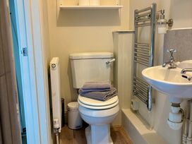 A bathroom with a toilet and hand basin at Clearbrook Lodge in Llanarthney, nr Llandeilo, Carmarthenshire