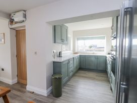 A kitchen with cabinets and a sink at Morannedd in Morfa Nefyn