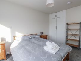 A bedroom with a bed and bedside table at Morannedd in Morfa Nefyn