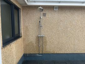 An outdoor shower on a wall at Morannedd in Morfa Nefyn