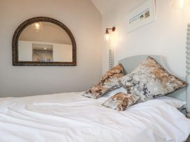 A bedroom with a bed and decorative pillows at Beach View House in Newquay